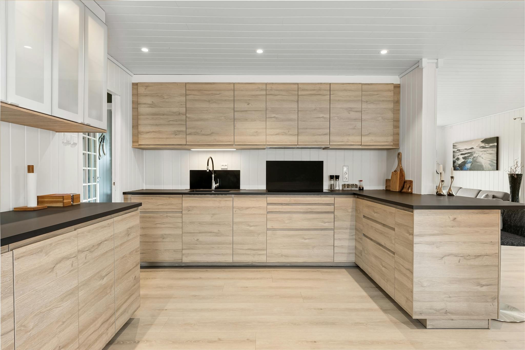 Spacious modern kitchen with wooden cabinetry and sleek design elements.